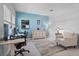 Inviting office space with a blue accent wall, patterned armchair, and ample natural light at 5220 Red Coral Cir, Mount Dora, FL 32757