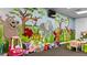Bright and playful playroom with colorful murals, toys, and seating areas for activities at 5220 Red Coral Cir, Mount Dora, FL 32757