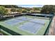 Aerial view featuring well-maintained tennis courts ready for play within a beautiful community setting at 5220 Red Coral Cir, Mount Dora, FL 32757