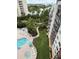 Offers an aerial view of a pool, landscape, and surrounding structures at 6165 Carrier Dr # 1801, Orlando, FL 32819