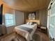 Cozy bedroom with wood accents, natural light, and stylish decor at 6165 Carrier Dr # 1801, Orlando, FL 32819