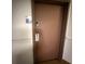 Condo front door with a keypad, modern handle and dark wood trim, providing a secure entrance to the residence at 6165 Carrier Dr # 1801, Orlando, FL 32819