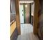 Unique hallway design featuring wooden accents, and neutral flooring offering a stylish path to the living areas at 6165 Carrier Dr # 1801, Orlando, FL 32819