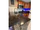 Features a breakfast bar with dark countertop and wood-accented design at 6165 Carrier Dr # 1801, Orlando, FL 32819