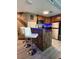Features a breakfast bar with two modern chairs, and stainless steel appliances at 6165 Carrier Dr # 1801, Orlando, FL 32819