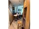 Living area with a wet bar, bar stools, and modern cabinets seamlessly blending entertainment and relaxation at 6165 Carrier Dr # 1801, Orlando, FL 32819