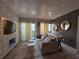 Stylish living room featuring a comfortable sofa, electric fireplace, and modern decor at 6165 Carrier Dr # 1801, Orlando, FL 32819