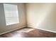 A cozy bedroom featuring a window with blinds and wood-look flooring at 6451 Old Park Ln # 407, Orlando, FL 32835