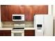 Well-equipped kitchen featuring stainless appliances, wood cabinetry, and durable countertops at 6451 Old Park Ln # 407, Orlando, FL 32835