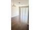 Bright living room with hardwood floors, a contemporary chandelier, and sliding door access to balcony at 6451 Old Park Ln # 407, Orlando, FL 32835