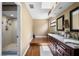 Bathroom featuring double sinks, granite countertops, wood floors, and a walk-in shower at 6460 Parson Brown Dr, Orlando, FL 32819