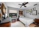 Comfortable bedroom with serene decor, a ceiling fan, and a view of the lake at 6460 Parson Brown Dr, Orlando, FL 32819