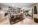 Charming dining area with built-in shelving, a rustic wooden table, and access to an enclosed porch at 6460 Parson Brown Dr, Orlando, FL 32819