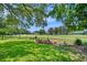 Expansive view of the lush green golf course, framed by mature trees and landscaping at 6460 Parson Brown Dr, Orlando, FL 32819