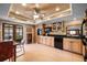 Well-lit kitchen boasts wood cabinets, black appliances, and a breakfast area overlooking the outdoors at 6460 Parson Brown Dr, Orlando, FL 32819