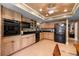 Functional kitchen features light wood cabinetry, black appliances, and tile flooring at 6460 Parson Brown Dr, Orlando, FL 32819