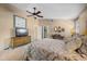 Comfortable bedroom features a ceiling fan, television, and neutral walls, creating a cozy retreat at 6460 Parson Brown Dr, Orlando, FL 32819
