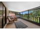 Relaxing screened porch with neutral furniture and a scenic view of the lush surroundings at 6460 Parson Brown Dr, Orlando, FL 32819