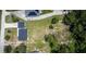 This aerial view showcases the property's expansive green space and multiple buildings on the land at 655 N Arnold Ave, Groveland, FL 34736