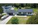 Aerial view of a home with a detached garage and a boat parked in the driveway at 655 N Arnold Ave, Groveland, FL 34736