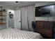 Comfortable bedroom featuring decorative shelving, a TV, and neutral-toned decor at 655 N Arnold Ave, Groveland, FL 34736