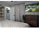Bedroom featuring a bed, shelving and a television, offering a cozy and relaxing space at 655 N Arnold Ave, Groveland, FL 34736