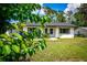 Inviting single-story home surrounded by lush greenery and a well-kept lawn at 655 N Arnold Ave, Groveland, FL 34736