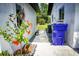Exterior corner of home with an orange flowering plant and a view of the yard at 655 N Arnold Ave, Groveland, FL 34736