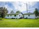 Charming home with a well-maintained lawn and detached garage or in-law suite at 655 N Arnold Ave, Groveland, FL 34736