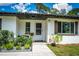 Charming front entrance with a welcoming decor and lush landscaping at 655 N Arnold Ave, Groveland, FL 34736