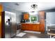 Well-equipped kitchen features stainless steel appliances, ample wooden cabinetry, and a modern sink with a window view at 655 N Arnold Ave, Groveland, FL 34736
