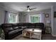 Inviting living room with a large sectional sofa, stylish coffee table, and plenty of natural light from the windows at 655 N Arnold Ave, Groveland, FL 34736