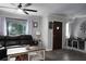 Comfortable living room with a plush leather sofa, stylish coffee table, and bright windows at 655 N Arnold Ave, Groveland, FL 34736