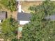 Aerial shot of home showing roof, patio, driveway, and pool surrounded by mature landscaping at 7375 Lake Dr, Sanford, FL 32771