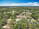 Wide aerial showcasing the neighborhood and surrounding lush trees at 7375 Lake Dr, Sanford, FL 32771