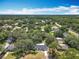 Aerial view of a residential neighborhood with mature trees, showcasing the home's location at 7375 Lake Dr, Sanford, FL 32771