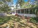 Backyard showcasing an above-ground pool, patio with grill, and ample space for outdoor relaxation at 7375 Lake Dr, Sanford, FL 32771