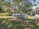 Backyard features an above-ground pool, and lawn surrounded by shade trees for outdoor enjoyment at 7375 Lake Dr, Sanford, FL 32771