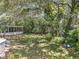 Backyard view showing an above-ground pool, surrounded by mature trees and lush greenery at 7375 Lake Dr, Sanford, FL 32771