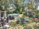 Backyard features a barbecue area, a fire pit with chairs, and an above-ground pool under a shady tree at 7375 Lake Dr, Sanford, FL 32771