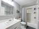 Neutral bathroom featuring a shower-tub combo, single sink vanity, and tile flooring at 7375 Lake Dr, Sanford, FL 32771