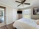 Bedroom featuring a ceiling fan, laminate flooring, and large windows for ample natural light at 7375 Lake Dr, Sanford, FL 32771