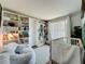 Bright Bedroom with built-in bookshelves, a crib, a comfortable chair, and laminate wood flooring at 7375 Lake Dr, Sanford, FL 32771