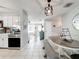 Bright dining area with pendant lighting, view of kitchen and entry, and hardwood flooring at 7375 Lake Dr, Sanford, FL 32771