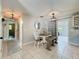 Inviting dining area with a wooden table, stylish seating, modern lighting, and an open connection to other rooms at 7375 Lake Dr, Sanford, FL 32771
