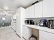 Bright kitchen featuring white cabinets, appliances, and an adjacent dining area, offering a clean and open layout at 7375 Lake Dr, Sanford, FL 32771