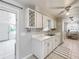 Bright kitchen features white cabinets, stainless steel appliances, a ceiling fan, and lots of natural light at 7375 Lake Dr, Sanford, FL 32771