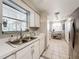 Bright kitchen with stainless steel sink and view of pantry area with shelving and storage at 7375 Lake Dr, Sanford, FL 32771