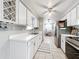 Well-lit kitchen boasts white cabinetry, stainless steel appliances, modern fixtures, and an adjacent dining area at 7375 Lake Dr, Sanford, FL 32771