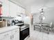 Kitchen featuring stainless steel range and view into the adjacent dining area with table and chairs at 7375 Lake Dr, Sanford, FL 32771